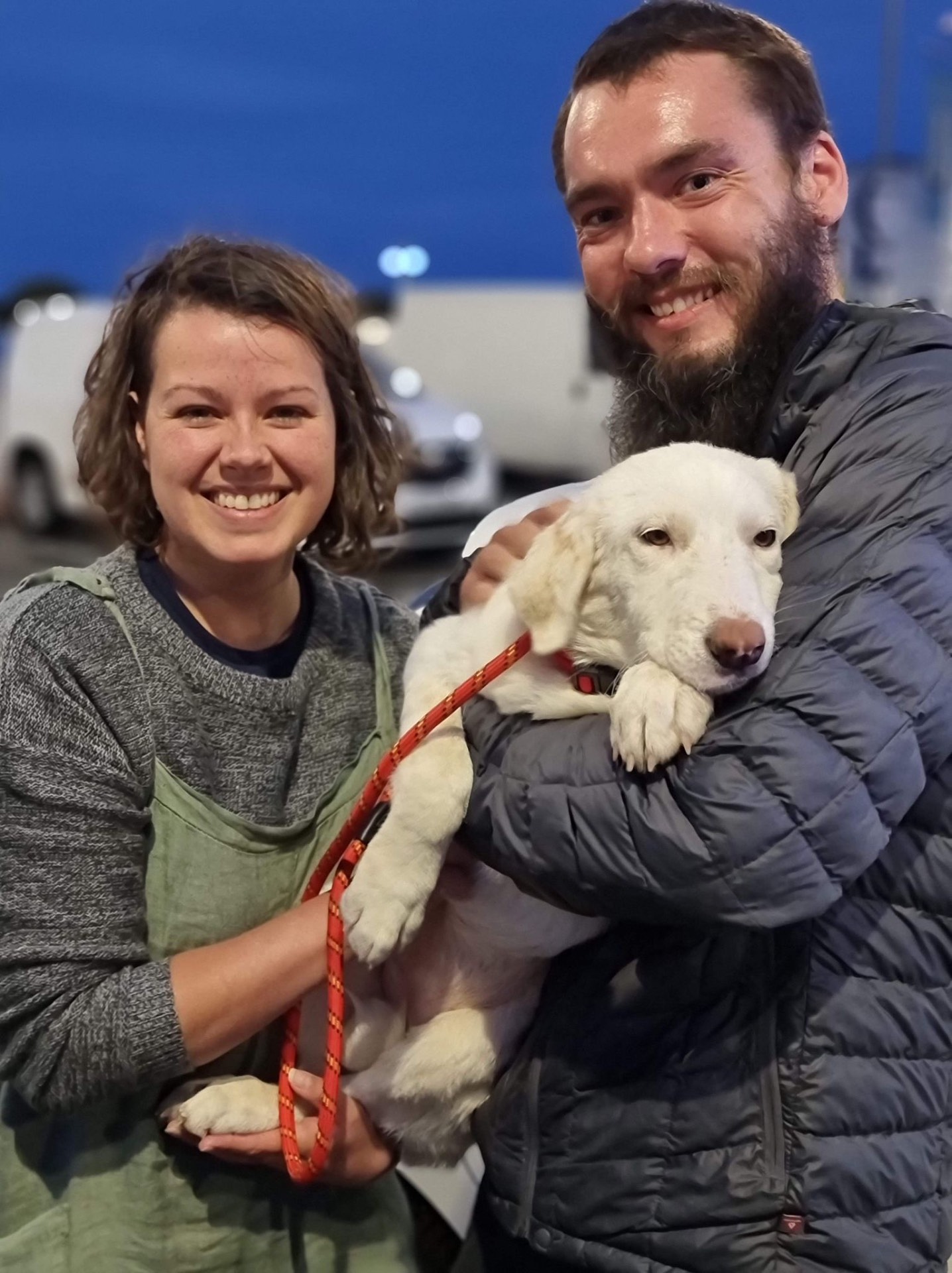 Jessica and Tim holding Lola, their rescue dog